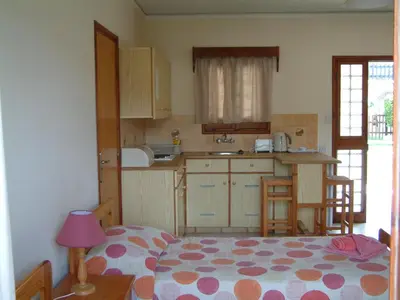 a small kitchen with a bed in a room at Pelekanos Apartments in Pissouri
