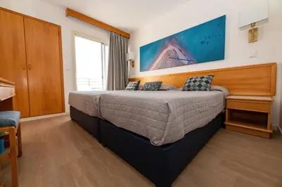 a bedroom with a large bed in a room at Tylos Beach Hotel in Kato Pyrgos