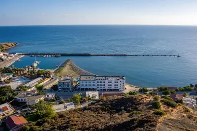 an aerial view of a resort near the ocean at Tylos Beach Hotel in Kato Pyrgos