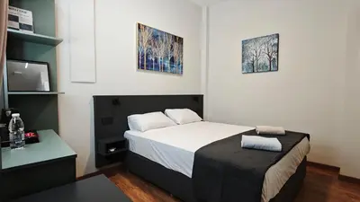 a small bedroom with a bed and a tv at St Lazarus City Hotel in Larnaka