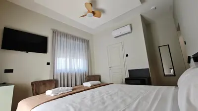 a bedroom with a large bed with two towels at St Lazarus City Hotel in Larnaka