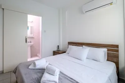 a bedroom with a large white bed with towels on it at The Coral Penthouse in Larnaka