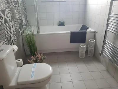a bathroom with a tub and a toilet and a sink at Evmelia Kakopetria Suites in Kakopetria