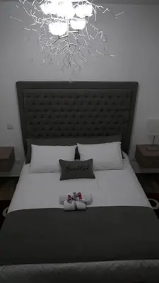 a bedroom with a large bed with two shoes on it at Evmelia Kakopetria Suites in Kakopetria