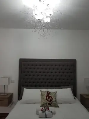 a bedroom with a large bed with a chandelier at Evmelia Kakopetria Suites in Kakopetria