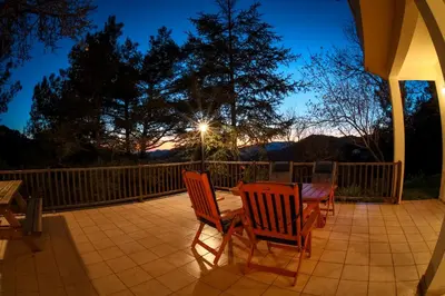 a patio with two chairs and a table at night at Forest Park Villa in Lemithou