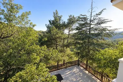 a balcony of a house with a view of trees at Forest Park Villa in Lemithou