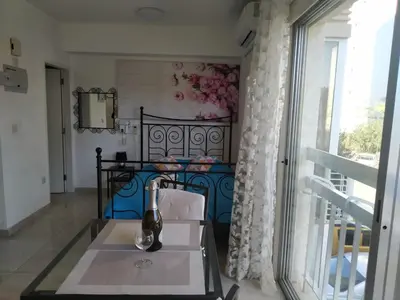 a kitchen with a table and a window at Stelia's Seagate Studio Apt. in Larnaka
