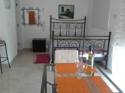 a table with a bottle of wine on top of it at Stelia's Seagate Studio Apt. in Larnaka