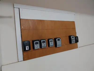 a mirror on a basketball court with a row of cell phones at Stelia's Seagate Studio Apt. in Larnaka