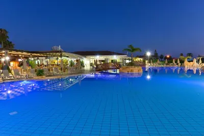 a large swimming pool at night at Makronisos Village in Ayia Napa