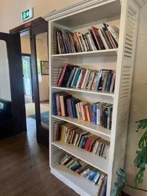a book shelf filled with books in a room at Jubilee Hotel Troodos in Troodos