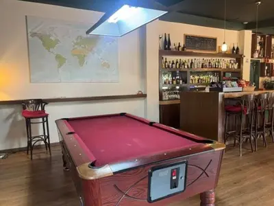 a pool table in front of a bar with a counter at Jubilee Hotel Troodos in Troodos