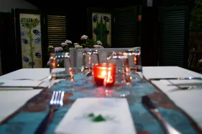 a table with a table cloth with a candle on it at Jubilee Hotel Troodos in Troodos
