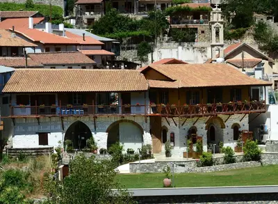 a large building with a balcony in a city at Casale Panayiotis in Kalopanayiotis