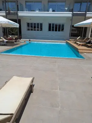 a large swimming pool in front of a building at Kapparis Apartment Mythical Sands in Protaras