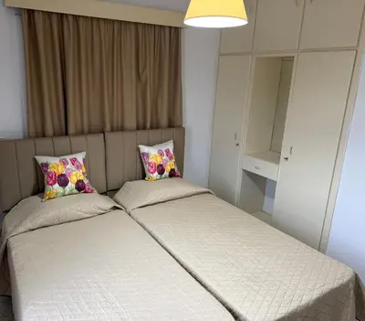 a bed with two pillows on it in a room at Terpsithea Apartments in Ayia Napa