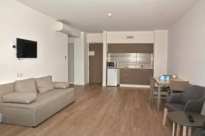 a living room with a couch and a table at Melini Hotel Suites in Protaras