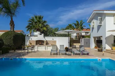 a villa with a swimming pool and a house at Larnaca Villa Anthea 12 in Larnaka