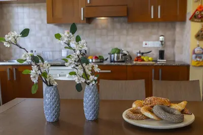 two vases on a table with a plate of bread at Larnaca Villa Anthea 12 in Larnaka