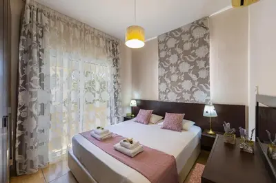 a bedroom with two beds and a window at Protaras Villa Rocco in Paralimni