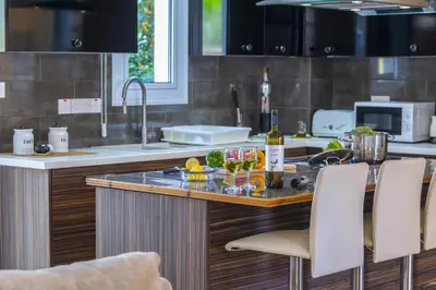 a kitchen with a counter with wine glasses on it at Protaras Villa Rocco in Paralimni