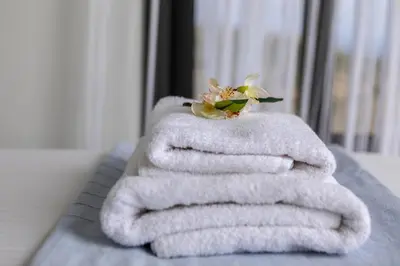 a stack of towels with a flower on top of it at Protaras Greco Hilltop Views in Protaras