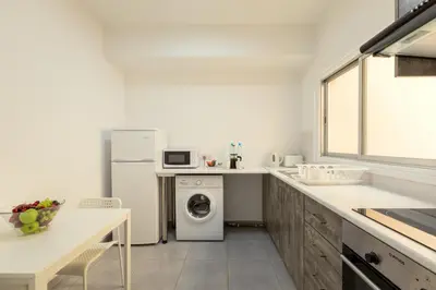a kitchen with a washing machine and a dishwasher at Savvas City Centre Flat in Larnaka