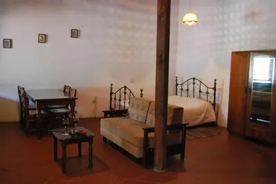a bedroom with a bed and a couch and a table at Xenis House in Galata