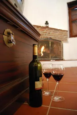 a bottle of wine and two glasses on a counter at Xenis House in Galata