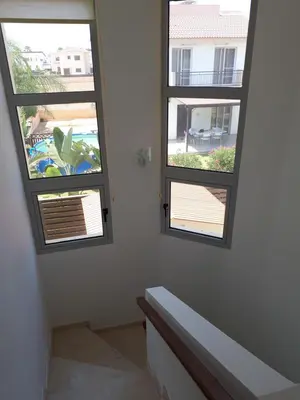 two windows in a room with a stair case at Villa Bouboulina Cyprus in Ayia Napa