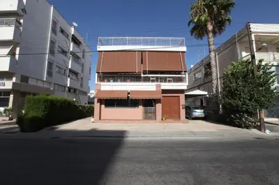 a building on a street with a parking lot at Nicosia Luxury Studio in Nicosia