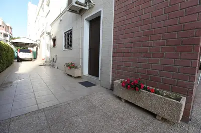 a red brick building with two benches with flowers at Nicosia Luxury Studio in Nicosia