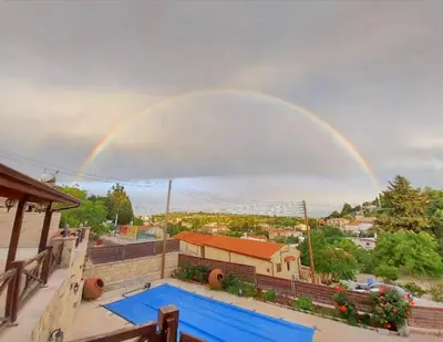 a rainbow over a house with a swimming pool at Villa Elizabeth in Limassol