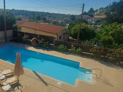 a swimming pool in front of a house at Villa Elizabeth in Limassol