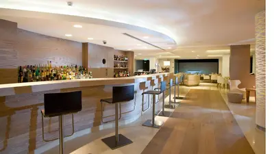 a bar with stools in a hotel lobby at Alasia Boutique Hotel in Limassol