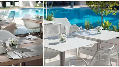 a table with white tables and chairs and a pool at Alasia Boutique Hotel in Limassol
