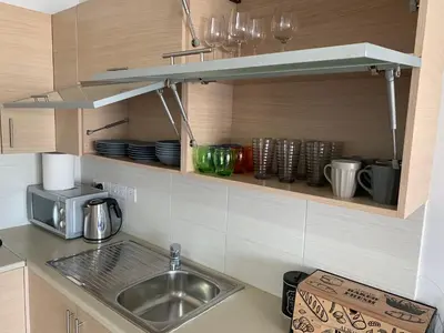 a kitchen counter with a sink and a microwave at Glabur Stays - The Nicosia Elite - Exceptional Top Floor Apartment Nicosia City, Welcomes U!!! in Nicosia