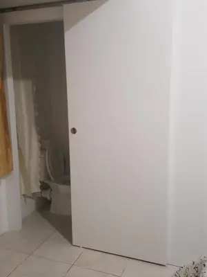 a bathroom with a toilet and a white door at City Large Studio in Limassol