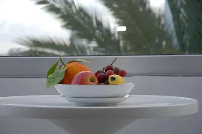 a bowl of fruit sitting on top of a table at Napa City Apartments in Ayia Napa