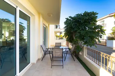 a patio with a table and chairs on a balcony at Villa Francesca in Paralimni