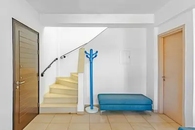 a stairway with a blue bench in a room at Villa Francesca in Paralimni
