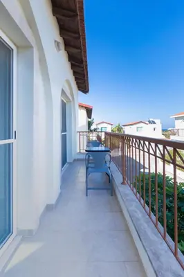 a balcony of a house with a table on it at Villa Francesca in Paralimni