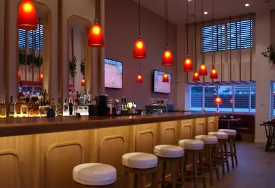 a bar with a row of stools in a restaurant at Sunrise Jade - Adults Only in Protaras