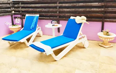 two blue and white rocking chairs in a room at Villa Sunrise in Paralimni