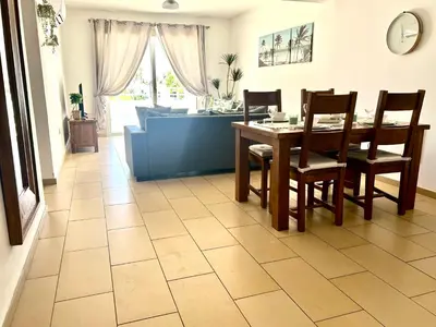 a dining room with a table and chairs on a tile floor at Nissi Sandy Bay C09 in Ayia Napa
