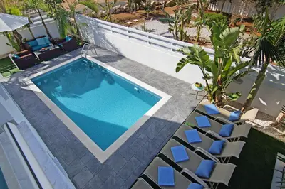 an overhead view of a swimming pool with lounge chairs at Villa Serena in Protaras