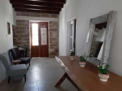 a room with a table and a chair and a mirror at Saint Antonio Maroni in Maroni