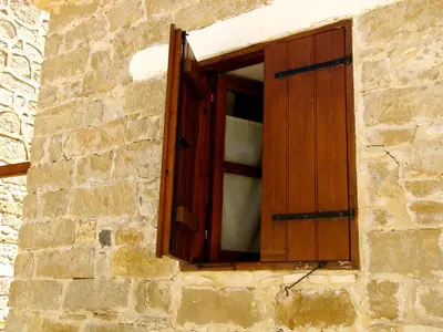 a wooden window on a stone building at Saint Antonio Maroni in Maroni