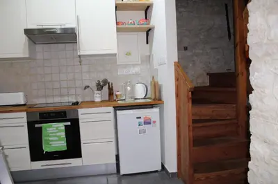 a kitchen with a white refrigerator and a staircase at Haven in Limassol
